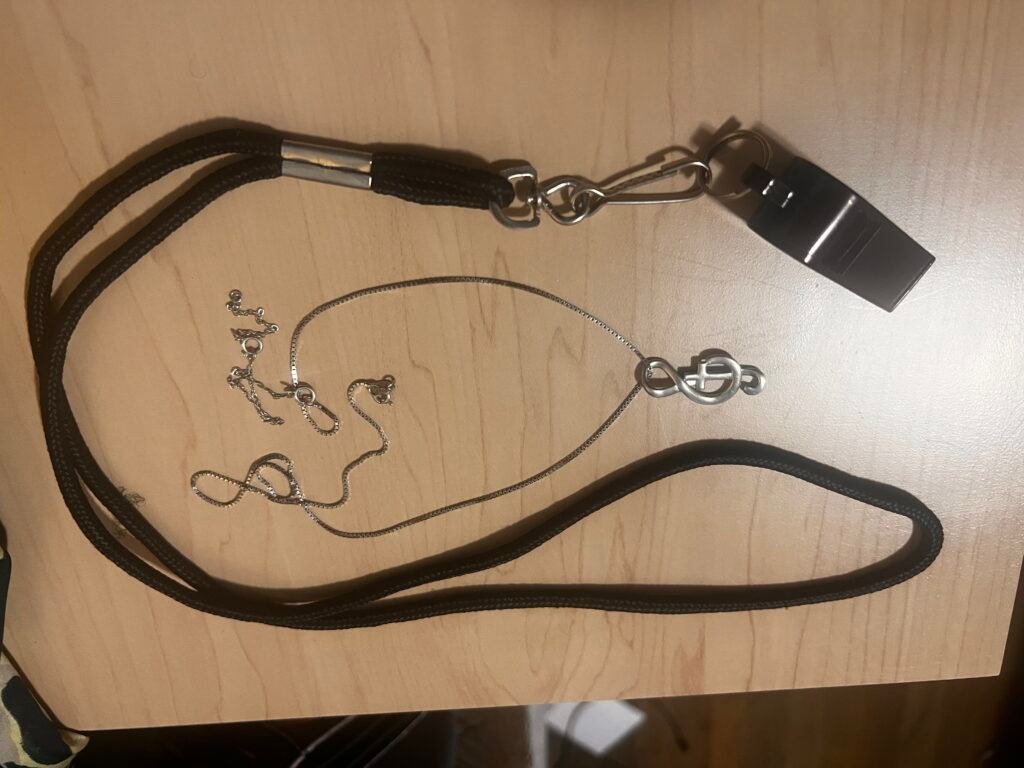 Dressing for God Or Society? necklace and whistle